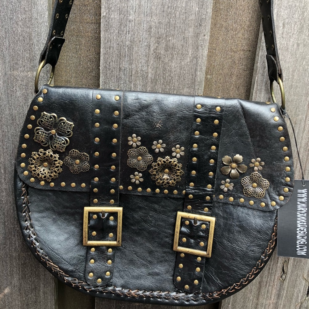 Black leather handbag with brass like flowers